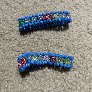 Two bracelets with multicolored gems interior and light blue embroidery